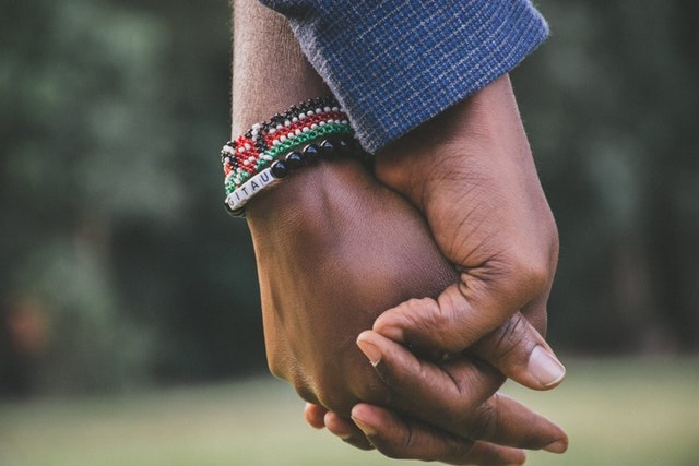 caring couple holding hands close-up